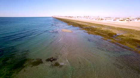 Aerial,-pullback-to-reveal-the-low-tide,-intertidal-beaches,-and-coastline-of-Rocky-Point,-the-Gulf-of-California,-Mexico