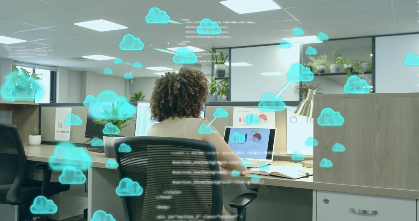 IT analyst studying laptop charts summoning floating cloud icons with code overlays for analytics