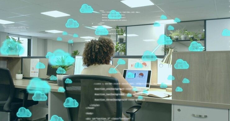 IT analyst studying laptop charts summoning floating cloud icons with code overlays for analytics