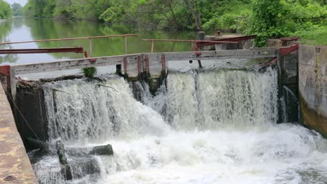 Agua-Que-Fluye-Sobre-Una-Presa-En-El-Histórico-Canal-Hennipen