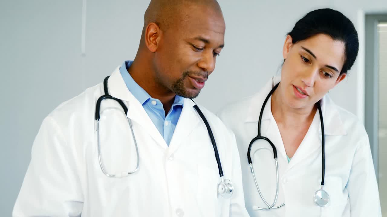 Two doctors discussing with the clipboard