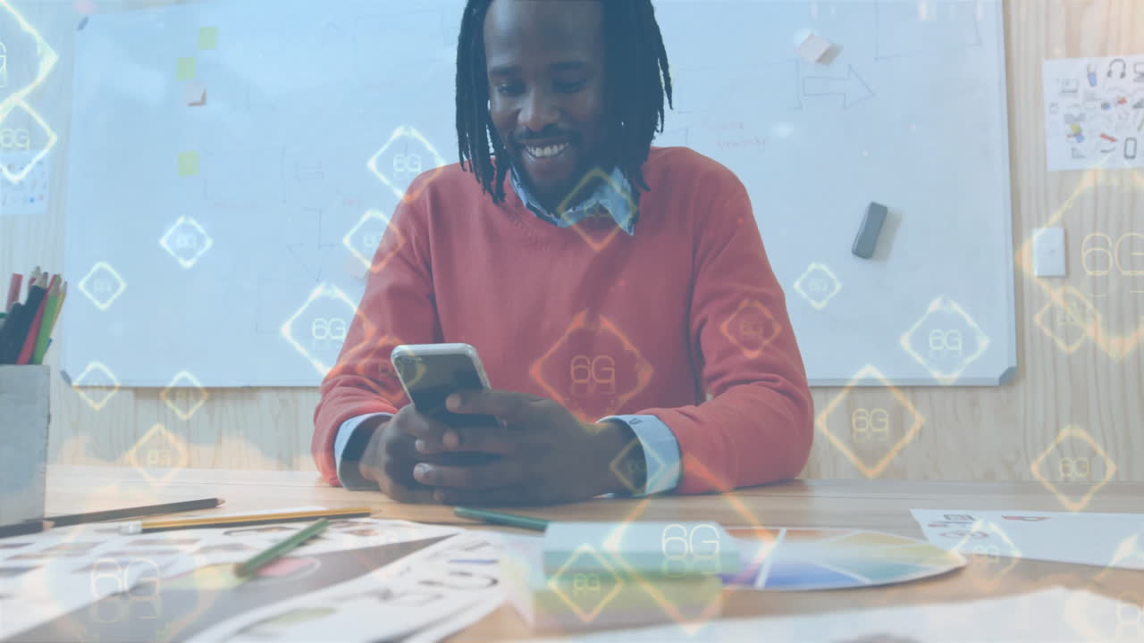 Smiling man using smartphone at desk with 6G technology animation overlay