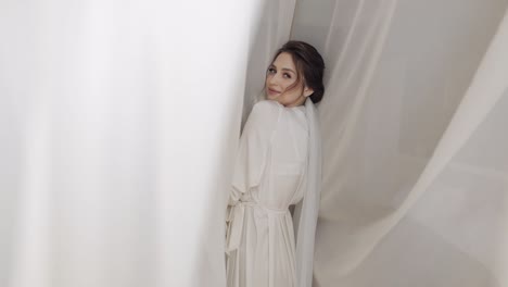 bride in boudoir dress near window, wedding morning preparations, woman in night gown and veil