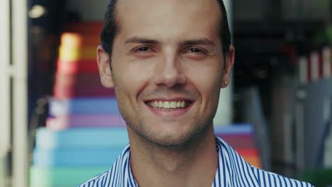 close-up portrait of a smiling man with a colorful background
