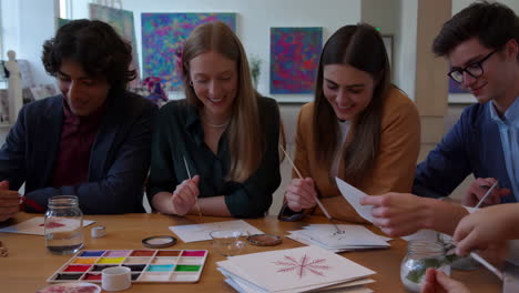 group of people painting at a table