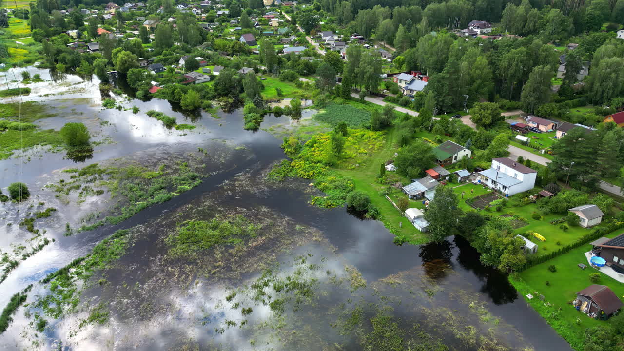 Drone orbit in one axle over beautiful village in Latvia, serene atmosphere in countryside
