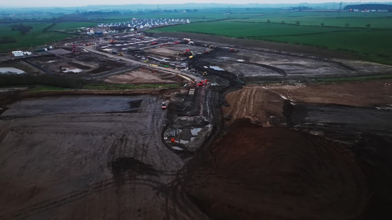 Aerial establishing shot of groundworks preparing the area for a housing estate