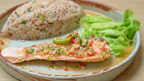 quinoa fried rice with steamed salmon in lime chilli dressing - healthy food style