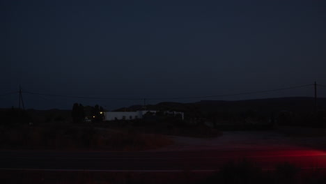 night view of a car driving on remote countryside road