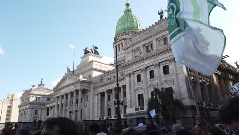 national congress of buenos aires city argentina with political flags waving people gather to protest in favor of public university