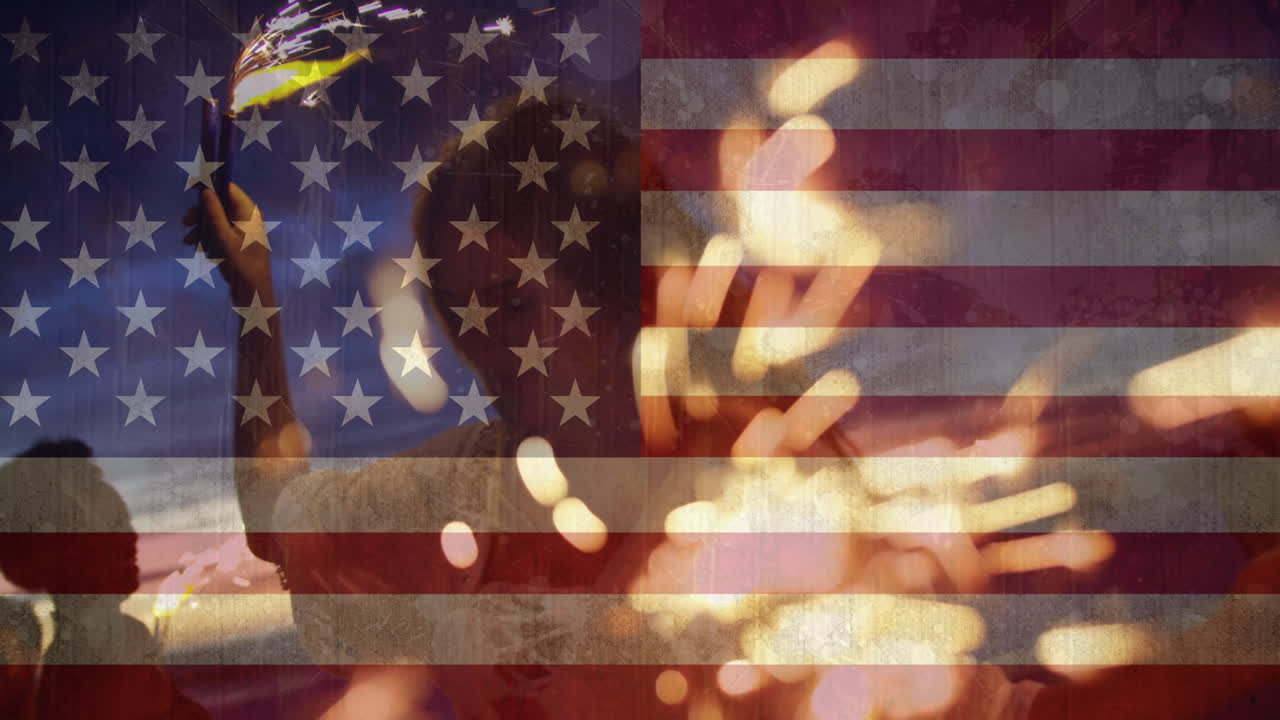 Animation of friends dancing with sparklers on beach against american flag waving