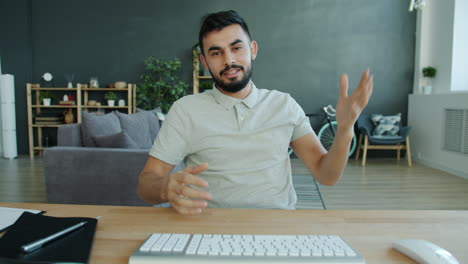 man giving a video presentation in a home office