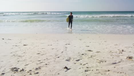 male surfer running with surfboard at beach 4k