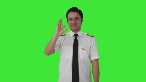 Happy-Indian-pilot-showing-okay-sign-Green-screen
