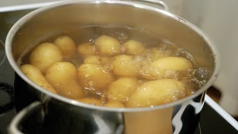 boiling potatoes are checked with a knife to see whether they are ready