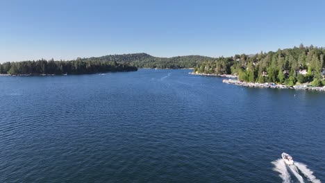 following a speed boat on lake arrowhead california bright sunny day aerial dolly