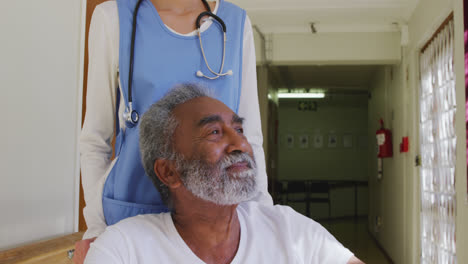 nurse helping a senior man in retirement house