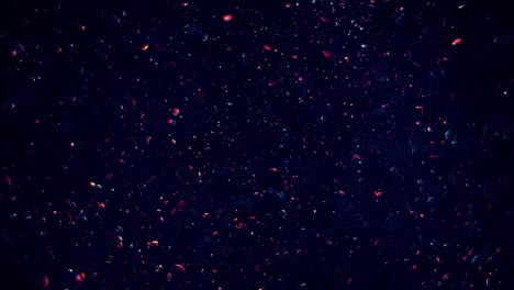 shimmering transparent bokeh dark blue bubbles moving slowly down on the dark blue background, glimmering with light red hint.