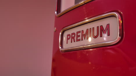 4k closeup of a premium gas pump in a red light studio