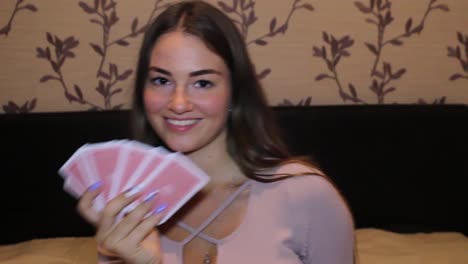 girl messing around while playing cards