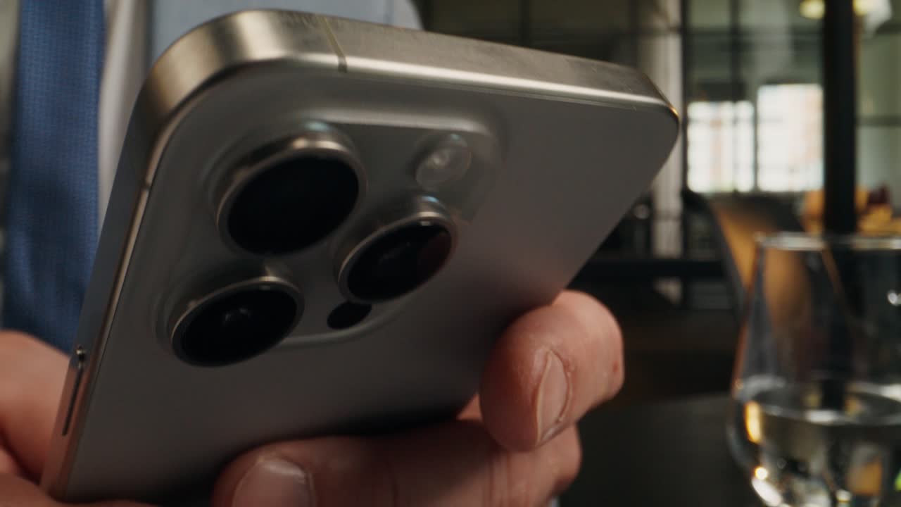 Businessman using smartphone in a cafe