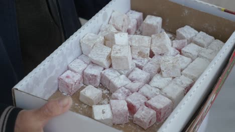 person holding a box of turkish delight