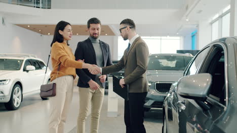 happy couple buying a car