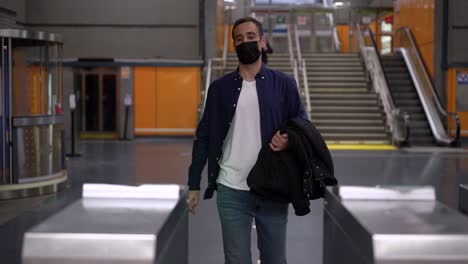 anonymous man passing through turnstile in subway