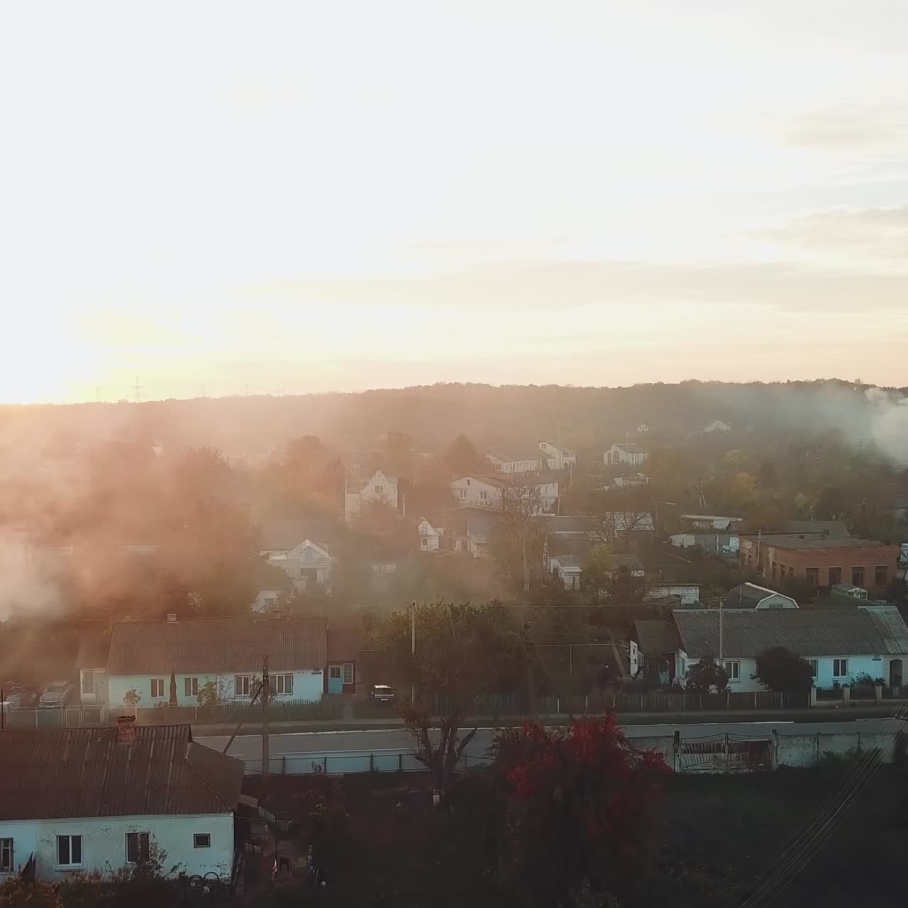 air above the city is filled with smoke after a fire from drought on the background of sunset. Aerial view