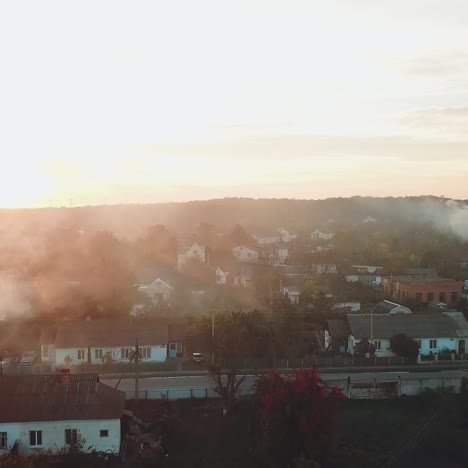 air above the city is filled with smoke after a fire from drought on the background of sunset. aerial view