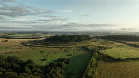 Aerial-shot-of-Badbury-Rings-on-a-summer-morning,-Dorset,-England