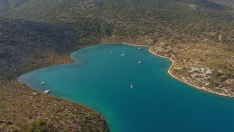 aerial: panoramic shot of natural harbor the bay of planitis in kira panagia island, sporades, greece