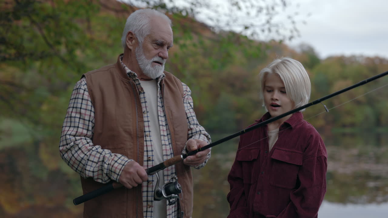 Grandfather Teaches Grandchild How to Fish