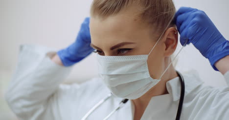 female doctor putting on protective mask at clinic 1