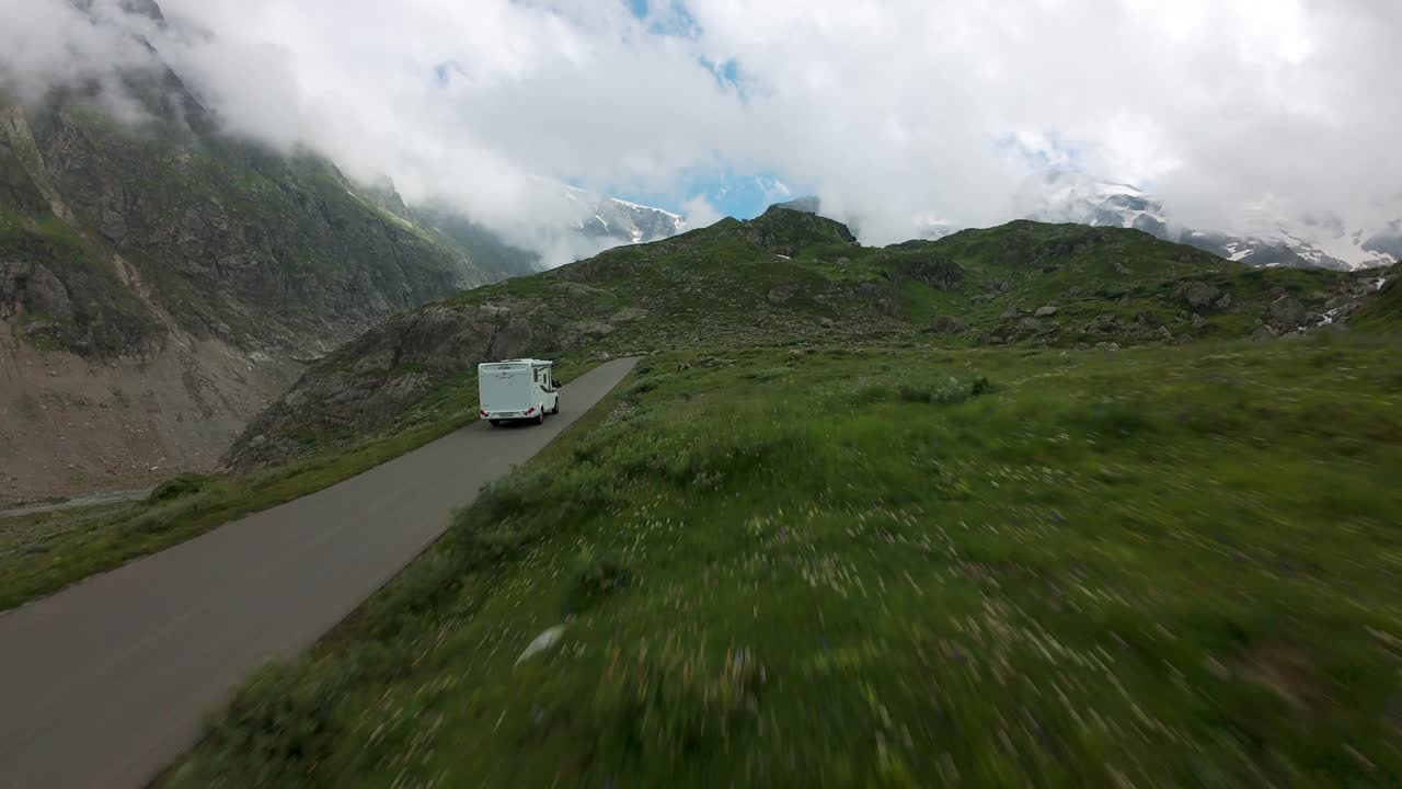 Susten Pass, Swiss Alps, Switzerland - People Walking and Cars Traveling Along the Scenic Road, With Glacial Streams Enhancing the View - FPV Shot