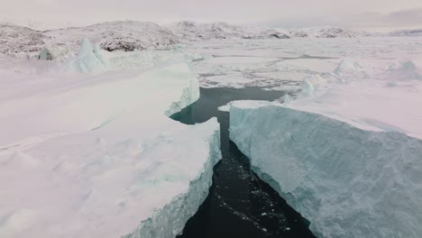 drone over sea and ice of ilulissat icefjord