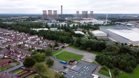 british industrial residential neighbourhood aerial view across power station suburban houses and streets panning left