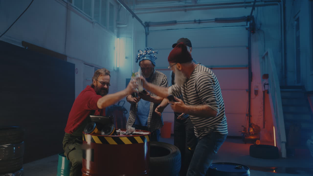 Friends socializing and celebrating a win in a garage