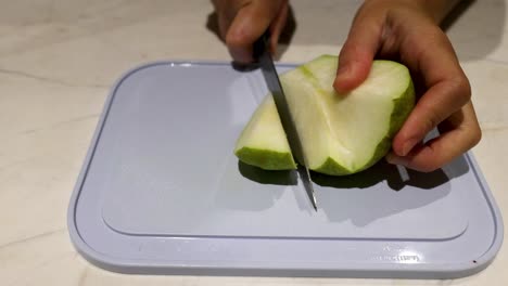 slicing a pear with a knife