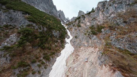 rugged concarena mountain landscape with rocky slopes and green patches during daytime