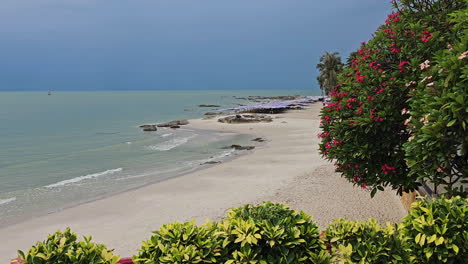Sandy-Beach-Coastline-in-Hua-Hin-with-Tropical-Lush-Trees-in-Foreground,-Prachuap-Khiri-Khan-Province,-Thailand