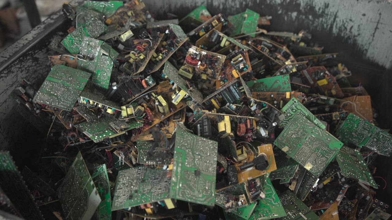 Heap Of Green Printed Circuit Boards In Metal Processing Bin, Layered Power Supplies And Modules, Close . Media
