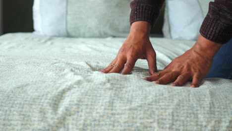 person making bed
