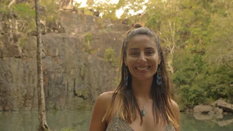 attractive and cheerful young woman during vacation in cedar creek falls, queensland, australia