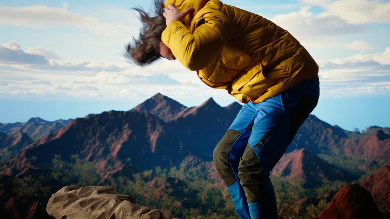 Hiker battling strong winds and cold weather tumbles over cliff on mountain top