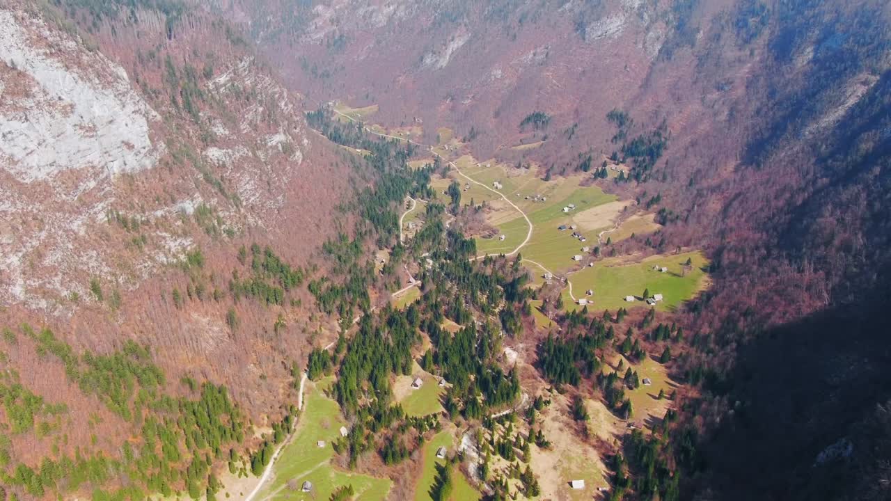 Wide angle dolly in Drone shot of beautiful mountains, valleys and hills in the Julian Alps during the day
