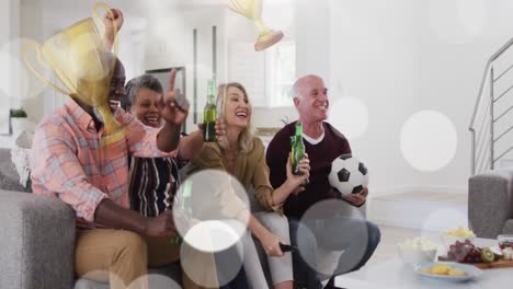 animation of cup icons over diverse group of seniors watching tv