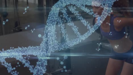animation of dna strand over muscular woman exercising