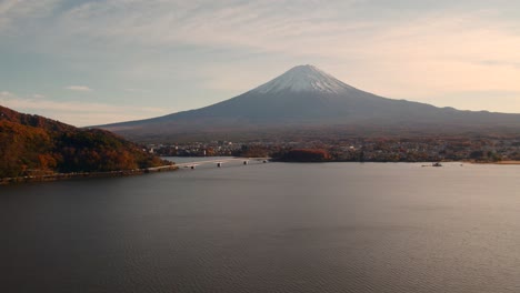 a rising drone shot of mount fuji in kawaguchiko, japan during the autumn season