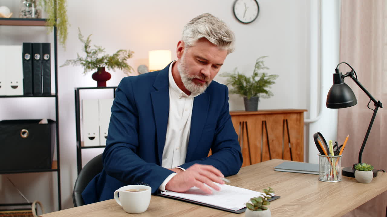 Middleaged businessman stretches enjoys aromatic coffee sip squints satisfied and resumes paperwork